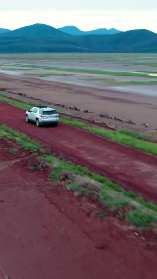 A pickup truck running across open desert and mountain roads